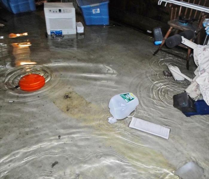 basement with 9 inches of standing water on the floor and items floating