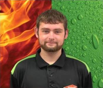 What will be a photo of Adam, one of our production techs, male employee in front of green and orange background